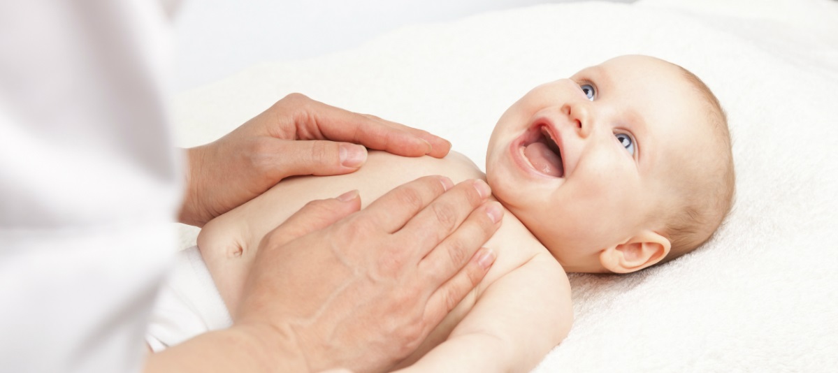 Baby smiling and getting a massage_0